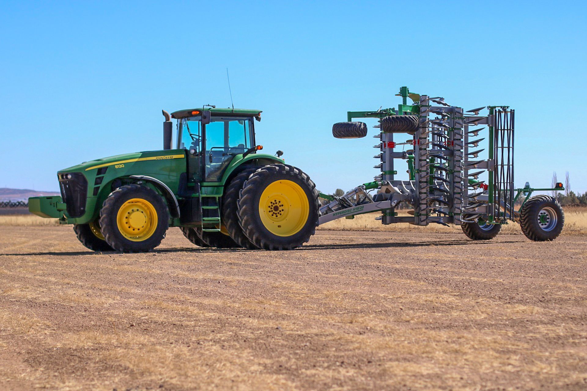APEX Hyperdisc H Series folded behind a John Deere tractor